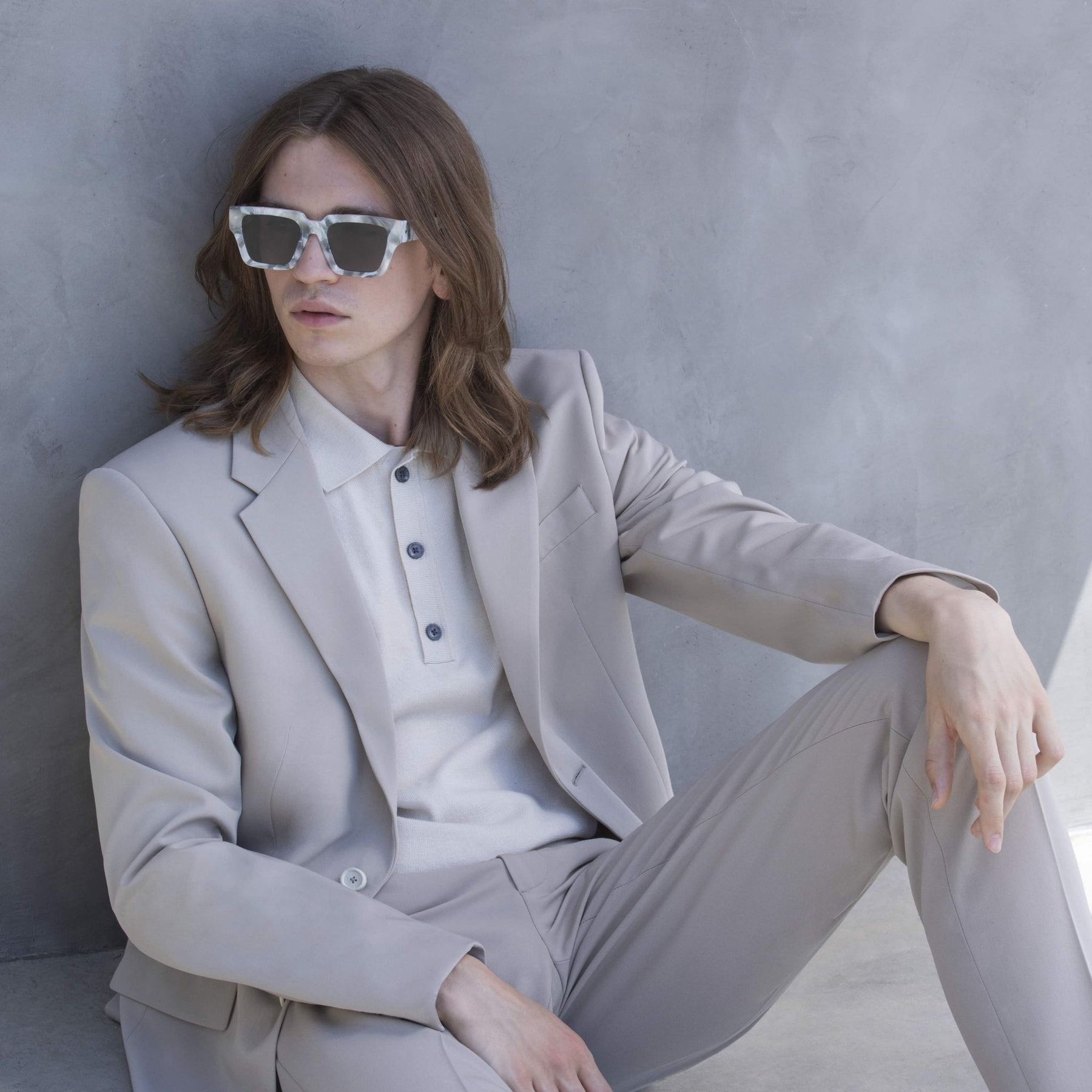 a woman wearing sunglasses sitting on a toilet 