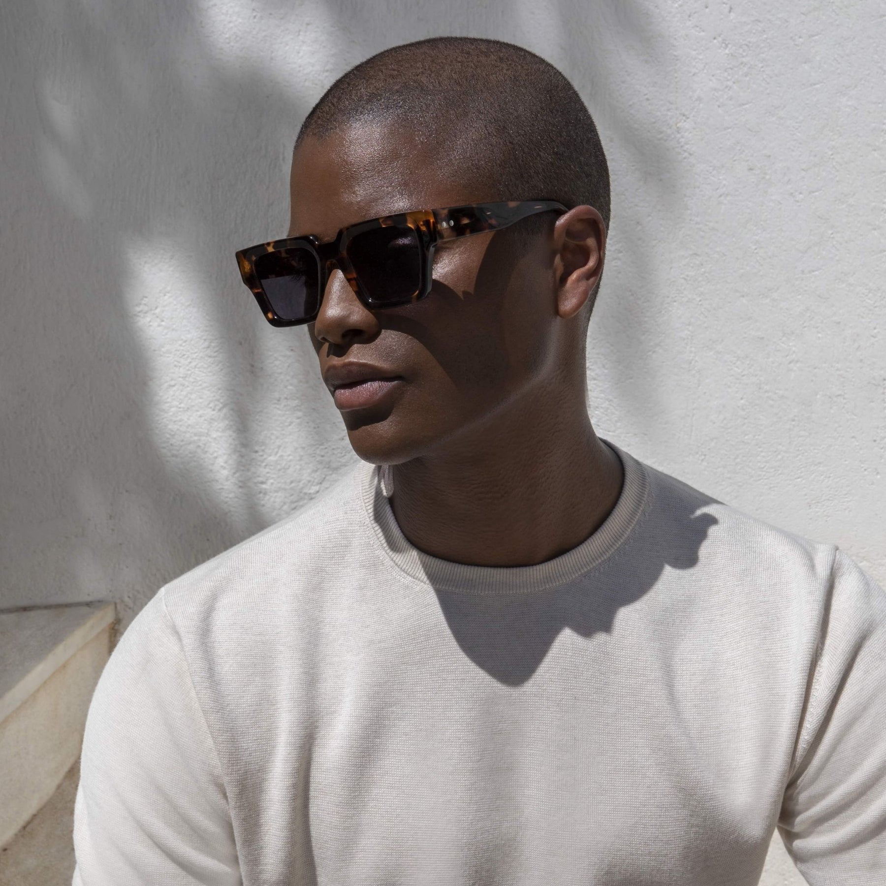 a man is wearing sunglasses and a hat 