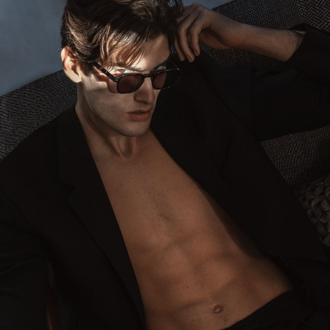 a man wearing sunglasses and a black shirt 