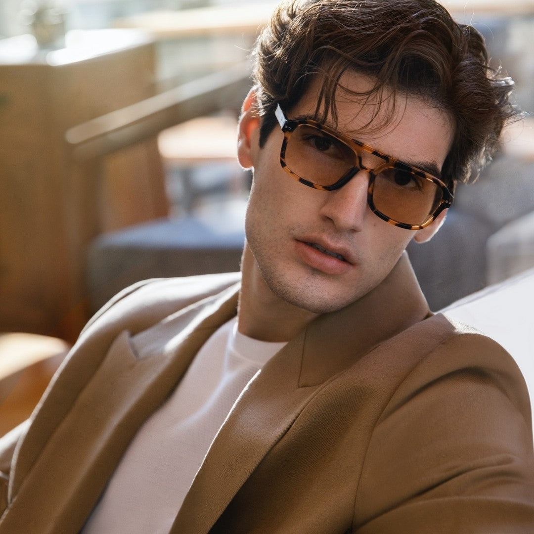 a man wearing glasses and a tie 